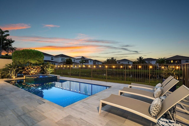 9657 Sterling Shores St, Delray Beach, FL 33446 - pool at dusk featuring a patio and a pool with connected hot tub