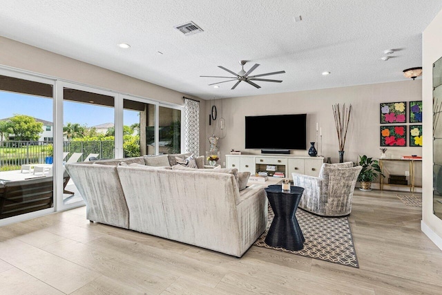 9657 Sterling Shores St, Delray Beach, FL 33446 - living area featuring a textured ceiling, ceiling fan, recessed lighting, and light wood-style floors