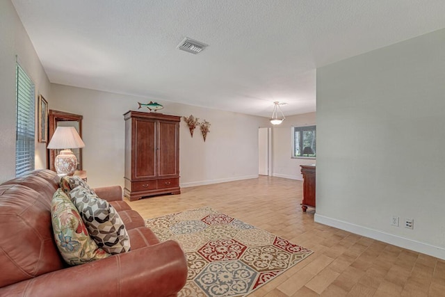 12275 N 54th St N, West Palm Beach, FL 33411 - living area with baseboards and a textured ceiling