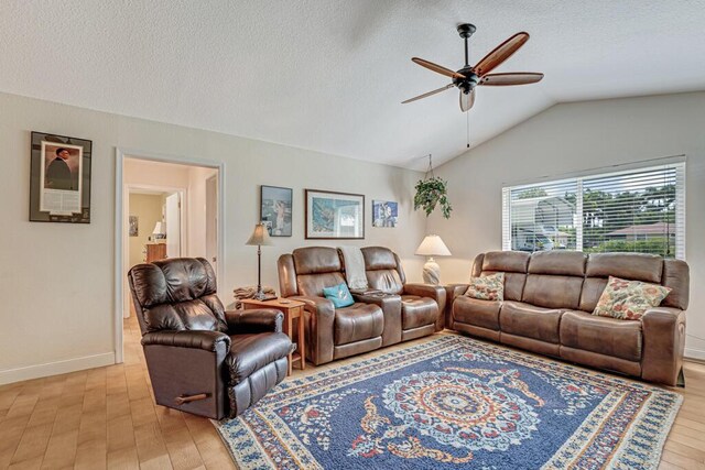 12275 N 54th St N, West Palm Beach, FL 33411 - living area with ceiling fan, light wood-style floors, vaulted ceiling, a textured ceiling, and baseboards