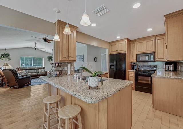12275 N 54th St N, West Palm Beach, FL 33411 - kitchen featuring black appliances, a sink, open floor plan, decorative backsplash, and lofted ceiling