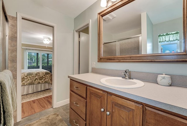 12275 N 54th St N, West Palm Beach, FL 33411 - full bathroom with vanity, an enclosed shower, tile patterned floors, ensuite bath, and a ceiling fan