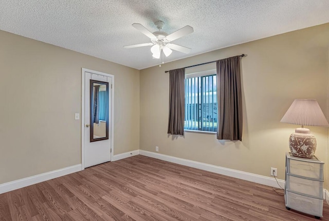 12275 N 54th St N, West Palm Beach, FL 33411 - spare room with wood finished floors, ceiling fan, a textured ceiling, and baseboards