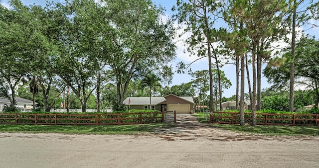 12275 N 54th St N, West Palm Beach, FL 33411 - single story home with a fenced front yard, a garage, and driveway