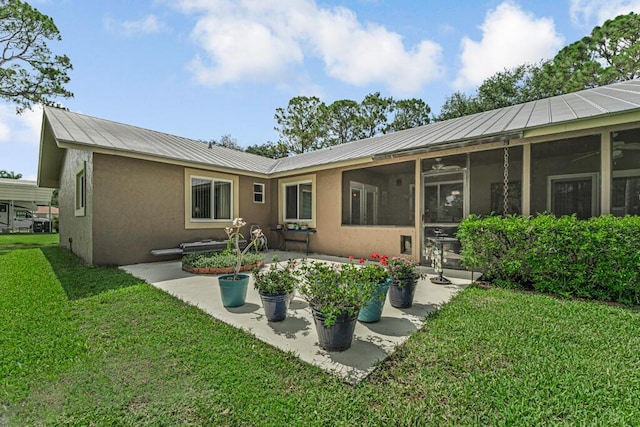 12275 N 54th St N, West Palm Beach, FL 33411 - rear view of property with stucco siding, a lawn, a sunroom, and metal roof