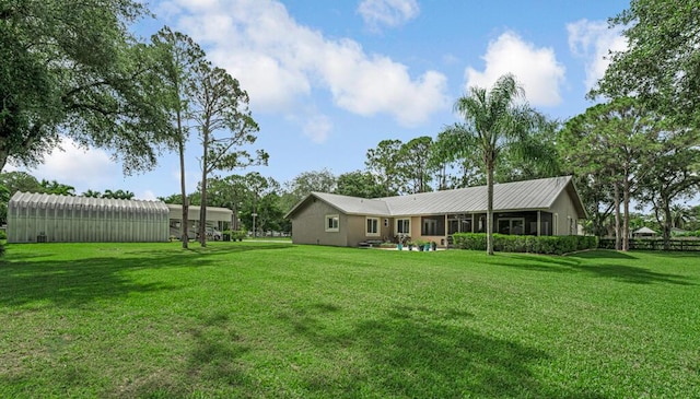 12275 N 54th St N, West Palm Beach, FL 33411 - back of property with a lawn, metal roof, a pole building, and an outdoor structure
