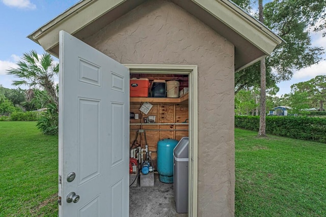 12275 N 54th St N, West Palm Beach, FL 33411 - view of exterior entry with a yard and stucco siding