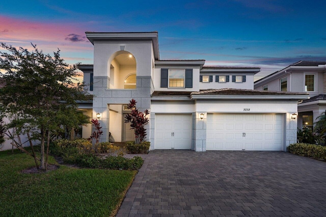 9258 Greenspire Ln, Lake Worth, FL 33467 - view of front of house with driveway, stucco siding, and a garage