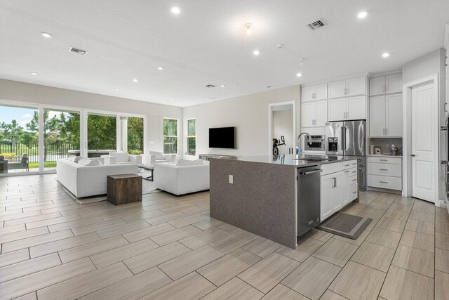 9258 Greenspire Ln, Lake Worth, FL 33467 - kitchen with appliances with stainless steel finishes, open floor plan, a sink, recessed lighting, and white cabinetry