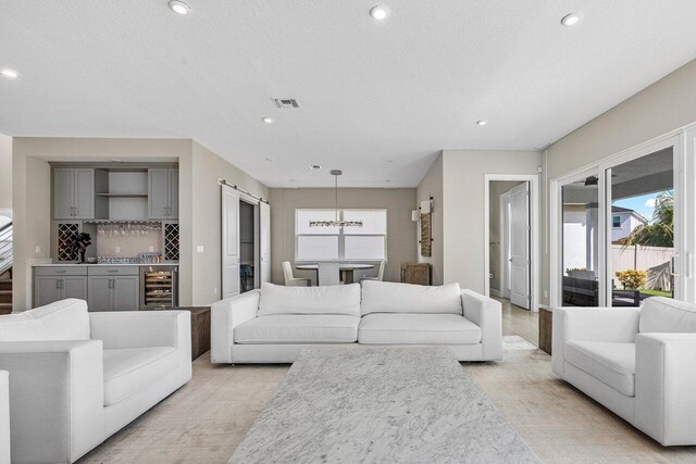 9258 Greenspire Ln, Lake Worth, FL 33467 - living room featuring wine cooler, recessed lighting, bar area, and a chandelier