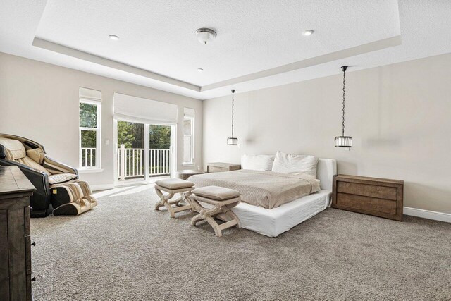 9258 Greenspire Ln, Lake Worth, FL 33467 - carpeted bedroom with a tray ceiling, access to outside, a textured ceiling, and baseboards