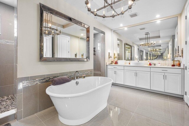 9258 Greenspire Ln, Lake Worth, FL 33467 - full bathroom with a chandelier, a freestanding bath, vanity, tile walls, and tile patterned floors