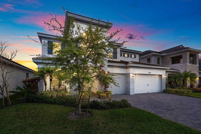 9258 Greenspire Ln, Lake Worth, FL 33467 - view of front of property featuring decorative driveway, stucco siding, and a yard
