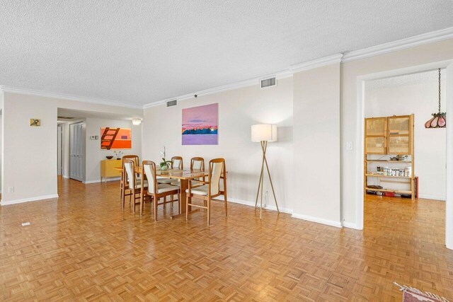 2001 N Ocean Blvd Unit 502, Boca Raton, FL 33431 - dining space with a textured ceiling, ornamental molding, and baseboards