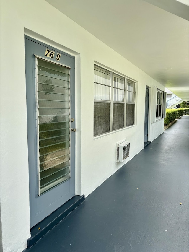 76 Cambridge Unit D, West Palm Beach, FL 33417 - property entrance featuring stucco siding