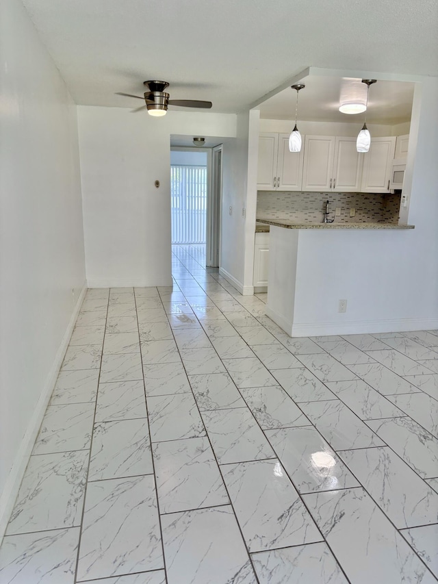 76 Cambridge Unit D, West Palm Beach, FL 33417 - unfurnished room with baseboards, light marble finish floors, and a ceiling fan