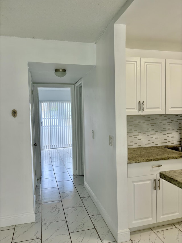 76 Cambridge Unit D, West Palm Beach, FL 33417 - hall with light marble finish floors and baseboards