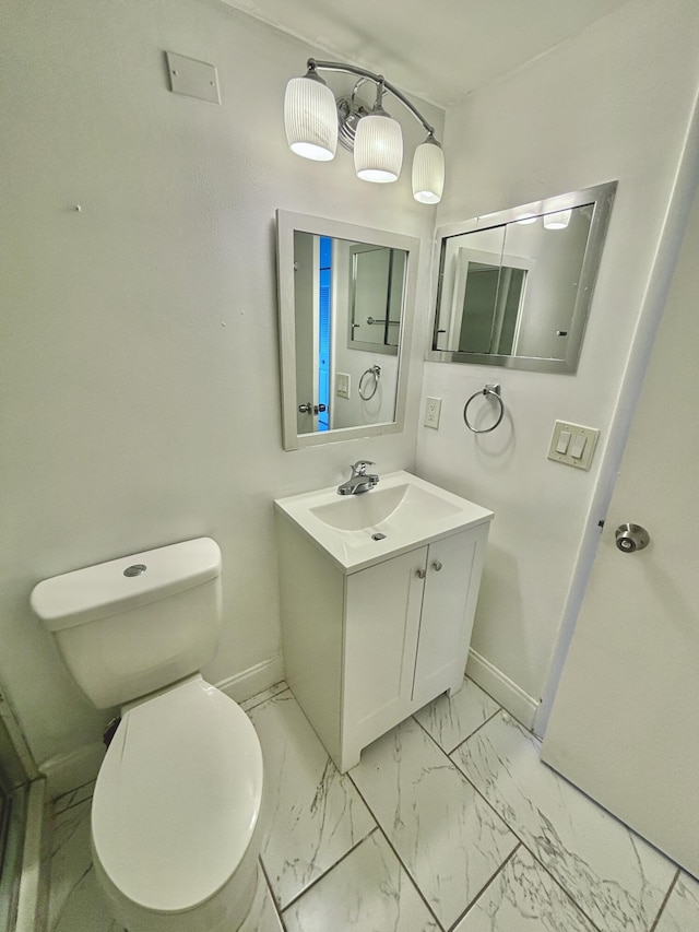 76 Cambridge Unit D, West Palm Beach, FL 33417 - bathroom with baseboards, vanity, toilet, and marble finish floors