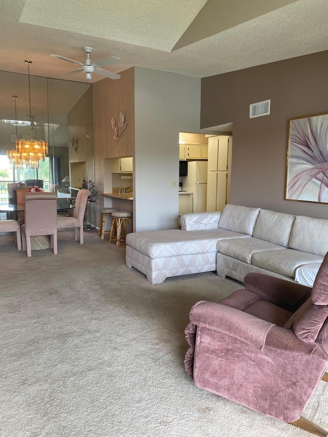 806 Sky Pine Way Unit G3, Greenacres, FL 33415 - carpeted living room with a chandelier, a ceiling fan, a textured ceiling, and high vaulted ceiling