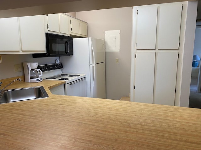 806 Sky Pine Way Unit G3, Greenacres, FL 33415 - kitchen with black microwave, a sink, white electric stove, light countertops, and white cabinets