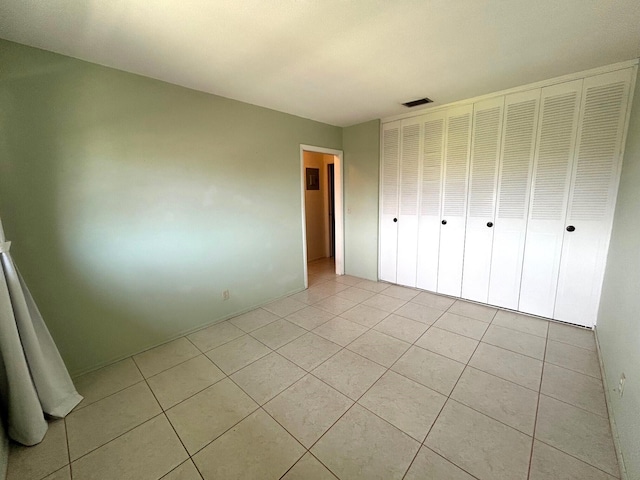 2802 Crosley Dr W Unit D, West Palm Beach, FL 33415 - unfurnished bedroom featuring light tile patterned flooring and a closet