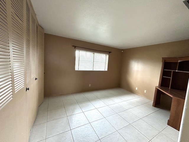 2802 Crosley Dr W Unit D, West Palm Beach, FL 33415 - unfurnished bedroom with light tile patterned floors and a closet