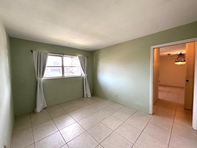 2802 Crosley Dr W Unit D, West Palm Beach, FL 33415 - empty room with light tile patterned flooring and a textured ceiling
