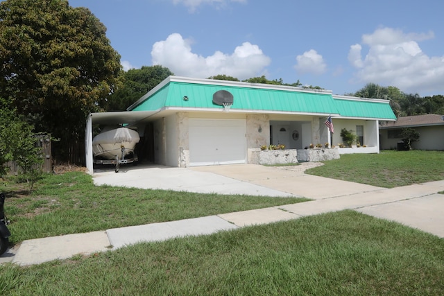 864 SE Tierra Ct, Port Saint Lucie, FL 34983 - view of front of property featuring a front yard, driveway, an attached carport, metal roof, and stucco siding