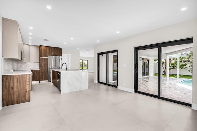 1182 SW 7th St, Boca Raton, FL 33486 - kitchen featuring modern cabinets, light countertops, backsplash, appliances with stainless steel finishes, and recessed lighting