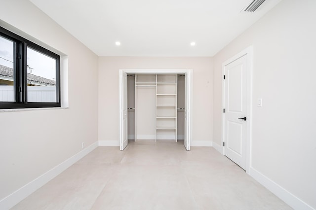1182 SW 7th St, Boca Raton, FL 33486 - unfurnished bedroom featuring baseboards, concrete floors, recessed lighting, and a closet
