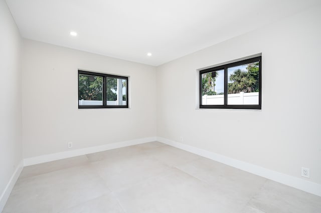 1182 SW 7th St, Boca Raton, FL 33486 - empty room with healthy amount of natural light, concrete flooring, baseboards, and recessed lighting