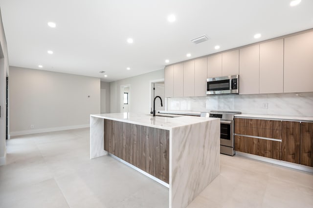 1182 SW 7th St, Boca Raton, FL 33486 - kitchen with stainless steel appliances, modern cabinets, an island with sink, a sink, and recessed lighting