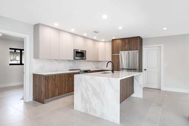1182 SW 7th St, Boca Raton, FL 33486 - kitchen with stainless steel appliances, modern cabinets, a sink, backsplash, and a center island with sink
