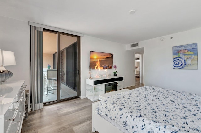 2701 N Ocean Blvd Unit E205, Boca Raton, FL 33431 - bedroom featuring access to exterior, light wood finished floors, and beverage cooler