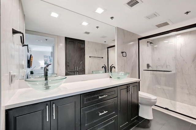 2701 N Ocean Blvd Unit E205, Boca Raton, FL 33431 - bathroom featuring toilet, double vanity, a marble finish shower, and tile patterned flooring