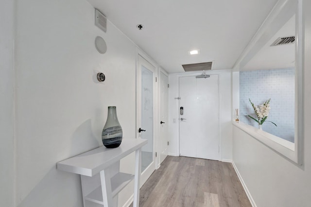 2701 N Ocean Blvd Unit E205, Boca Raton, FL 33431 - hallway with light wood finished floors and baseboards