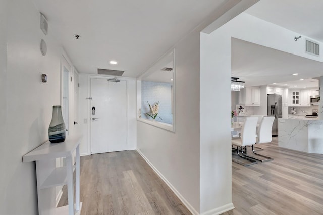 2701 N Ocean Blvd Unit E205, Boca Raton, FL 33431 - corridor with light wood finished floors and baseboards