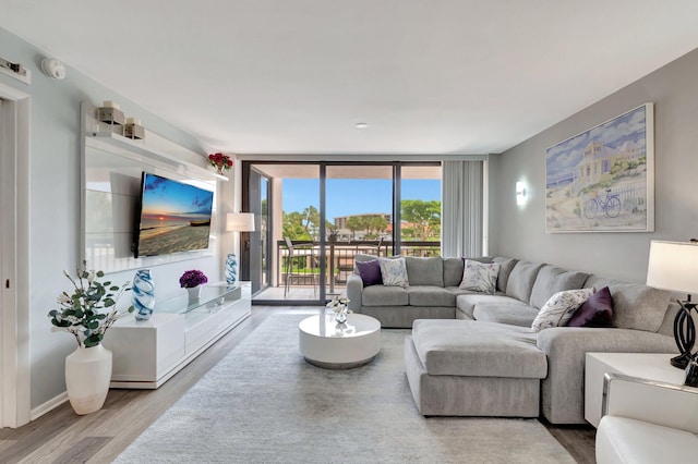 2701 N Ocean Blvd Unit E205, Boca Raton, FL 33431 - living room featuring a wall of windows and wood finished floors
