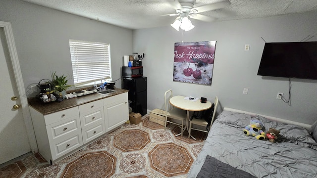 5692 Coconut Rd, West Palm Beach, FL 33413 - bedroom with a sink, a textured ceiling, baseboards, freestanding refrigerator, and ceiling fan