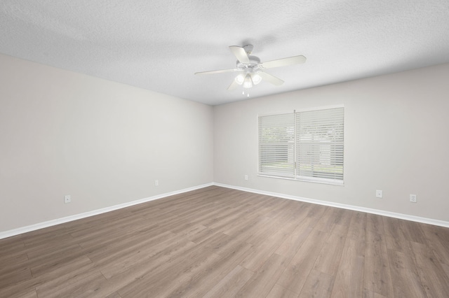 924 SW Abingdon Ave, Port Saint Lucie, FL 34953 - spare room with wood finished floors, ceiling fan, baseboards, and a textured ceiling
