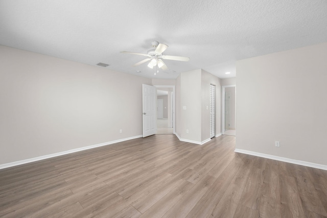 924 SW Abingdon Ave, Port Saint Lucie, FL 34953 - spare room featuring ceiling fan, wood finished floors, baseboards, recessed lighting, and a textured ceiling