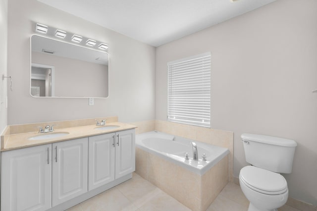 924 SW Abingdon Ave, Port Saint Lucie, FL 34953 - bathroom featuring double vanity, a garden tub, toilet, and tile patterned floors