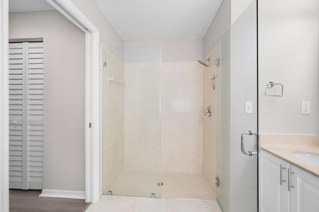 924 SW Abingdon Ave, Port Saint Lucie, FL 34953 - full bathroom with a stall shower, vanity, a closet, and baseboards