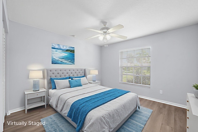924 SW Abingdon Ave, Port Saint Lucie, FL 34953 - bedroom featuring wood finished floors, baseboards, and a ceiling fan