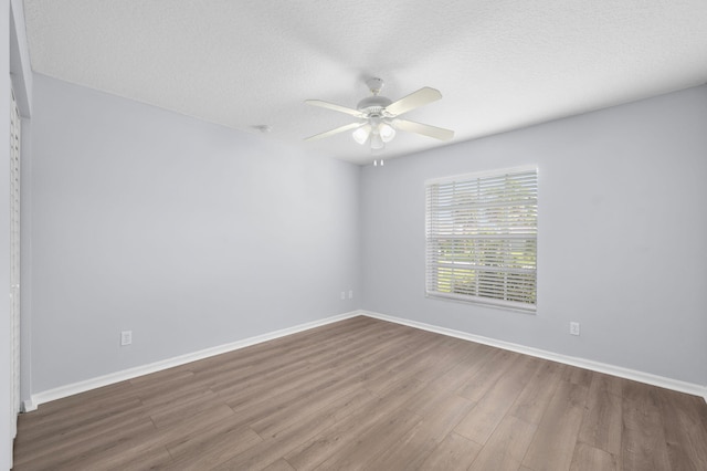 924 SW Abingdon Ave, Port Saint Lucie, FL 34953 - spare room with wood finished floors, ceiling fan, baseboards, and a textured ceiling