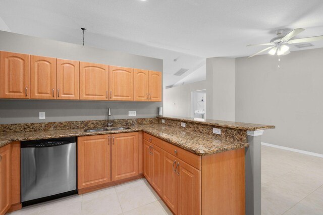 924 SW Abingdon Ave, Port Saint Lucie, FL 34953 - kitchen featuring stainless steel dishwasher, a sink, a peninsula, a ceiling fan, and dark stone counters