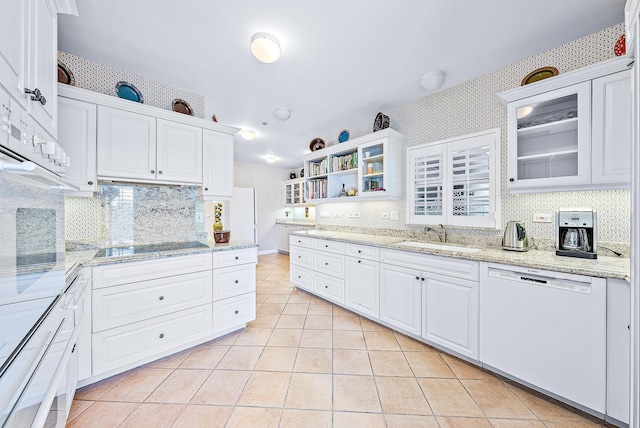2160 Ibis Isle Rd Unit 9, Palm Beach, FL 33480 - kitchen featuring white appliances, a sink, light tile patterned flooring, white cabinetry, and tasteful backsplash