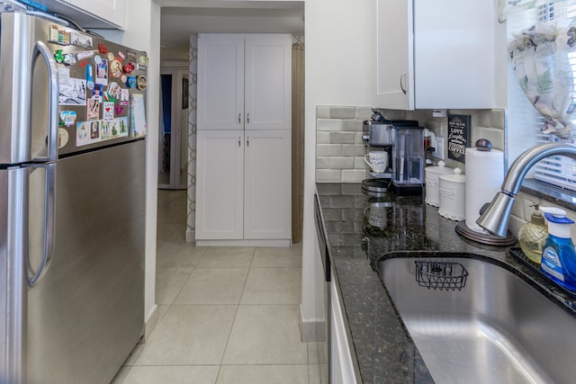 2755 W Atlantic Ave Unit 2208, Delray Beach, FL 33445 - kitchen with freestanding refrigerator, a sink, white cabinets, dark stone counters, and light tile patterned floors