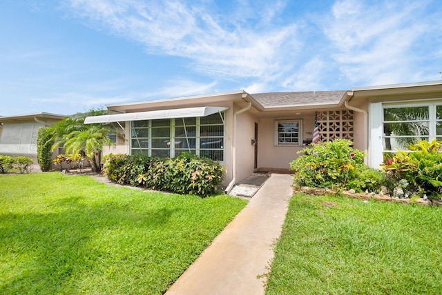 1250 Club Dr W Unit C, Delray Beach, FL 33445 - property entrance featuring a yard and stucco siding
