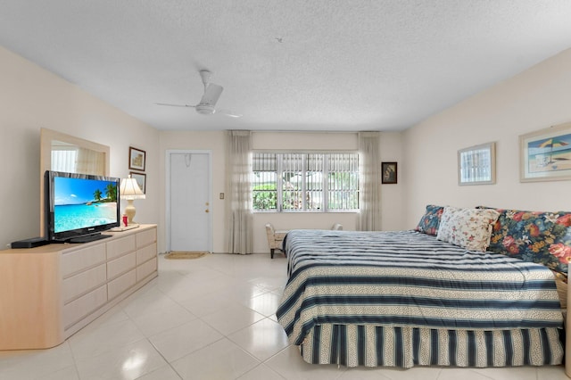 1250 Club Dr W Unit C, Delray Beach, FL 33445 - bedroom featuring a textured ceiling, a ceiling fan, and light tile patterned flooring